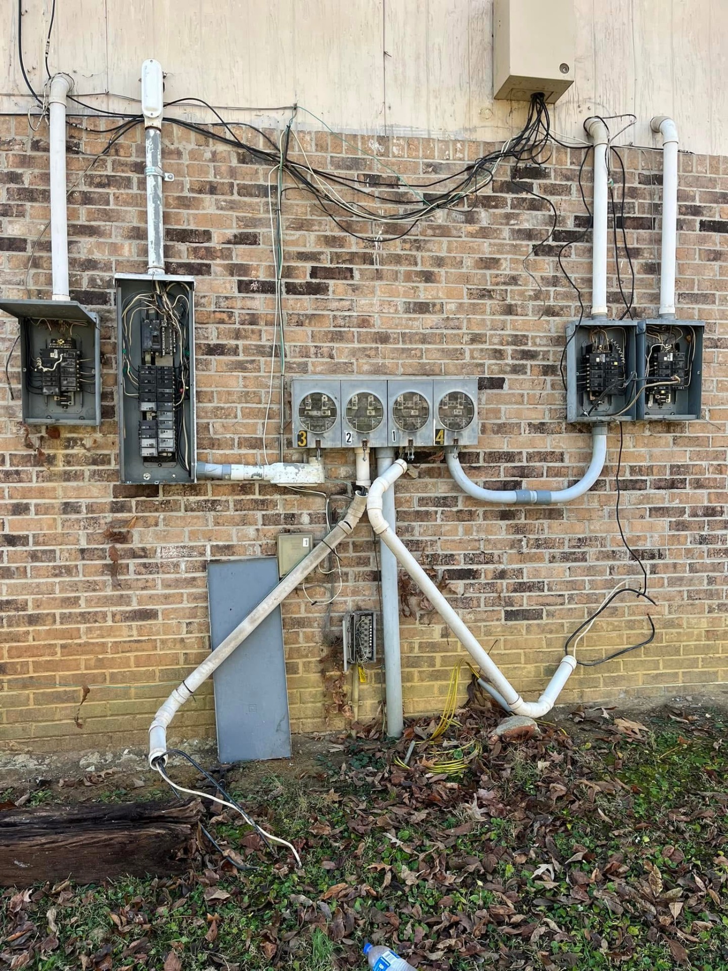 Tangled, unsafe electrical service before Bolt & Timber rebuild
